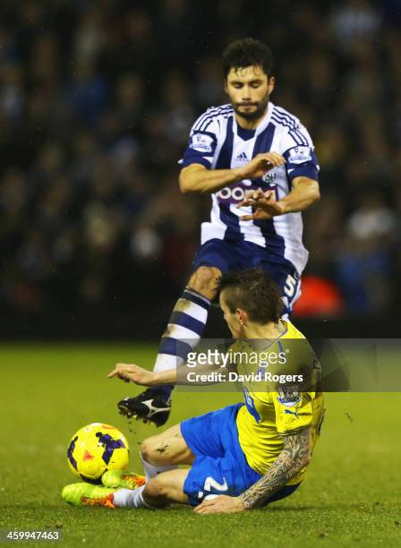 Mathieu Debuchy of Newcastle United challenges Claudio Yacob of West Bromwich Albion, a tackle leading to his sending off during the Barclays Premier...