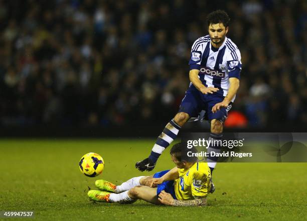 Mathieu Debuchy of Newcastle United challenges Claudio Yacob of West Bromwich Albion, a tackle leading to his sending off during the Barclays Premier...