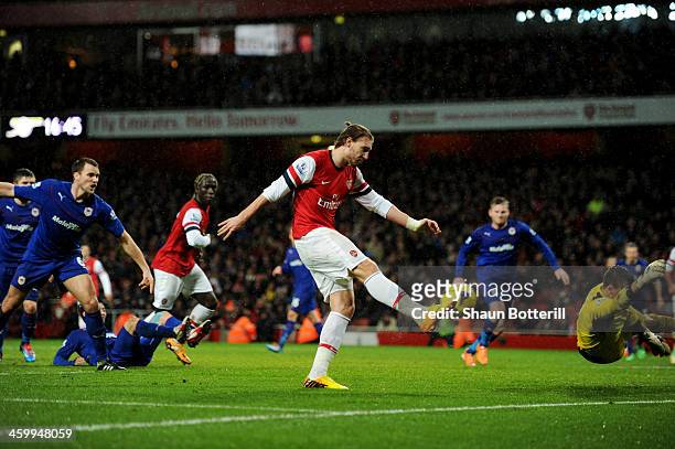 Nicklas Bendtner of Arsenal scores their first goal during the Barclays Premier League match between Arsenal and Cardiff City at Emirates Stadium on...