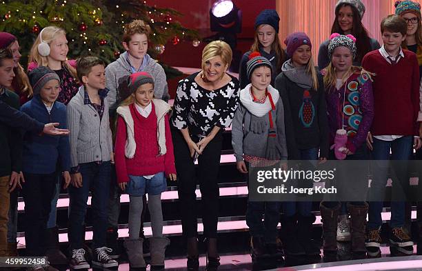 Carmen Nebel and the 'Lucky Kids' attend the TV show 'Die schönsten Weihnachtshits' on December 4, 2014 in Munich, Germany.