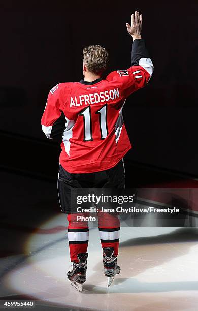 Daniel Alfredsson of the Ottawa Senators acknowledges the fans during prior to the ceremonial puck drop the day he announced his retirement prior to...