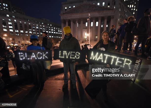 Protesters stand in Foley Square in New York City on December 4, 2014 during demonstration against the chokehold death of an unarmed black...