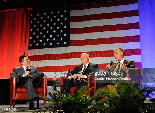 Steve Levy speaks with recipients of the Lester Patrick Trophy Bill Daly and Pul Holmgren during the U.S. Hockey Hall of Fame Induction Ceremony at...