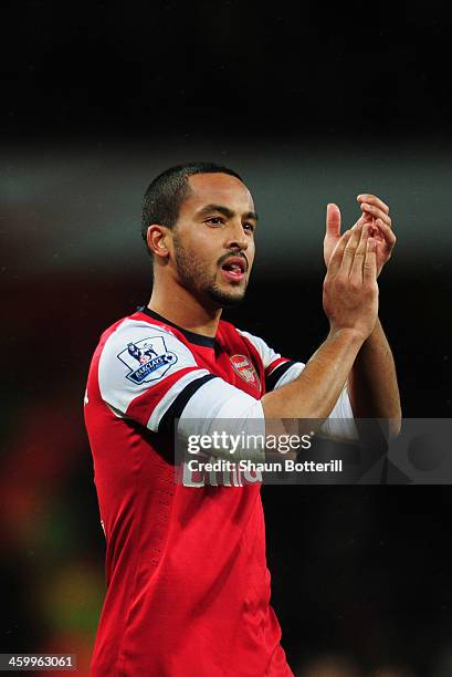 Theo Walcott of Arsenal applauds the crowd after the Barclays Premier League match between Arsenal and Cardiff City at Emirates Stadium on January 1,...