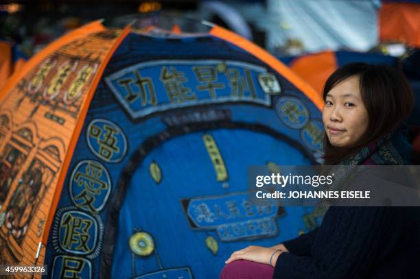 In this picture taken on on December 4 artist Helen Fan, one of the founders of the online glossary Umbrella Terms, sits next to a tent at the main...