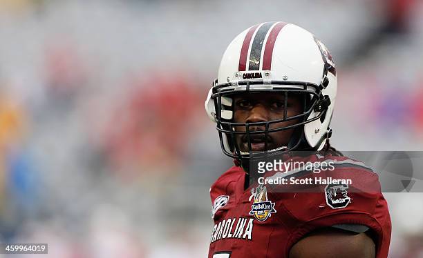 Jadeveon Clowney of the South Carolina Gamecocks works out on the field before the start of their game against the Wisconsin Badgers at the Capital...