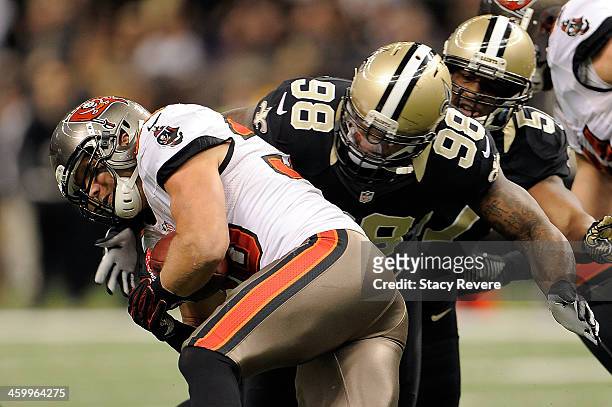 Brian Leonard of the Tampa Bay Buccaneers is tackled by Parys Haralson of the New Orleans Saints during a game at the Mercedes-Benz Superdome on...