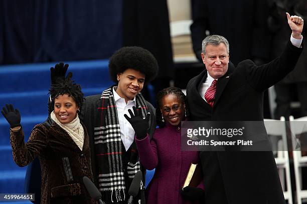 New York City's 109th Mayor Bill de Blasio walks onto stage with his family Chiara de Blasio Dante de Blasio and wife Chirlane McCray at City Hall on...