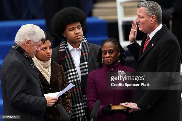 New York City's 109th Mayor, Bill de Blasio, is sworn in by former President Bill Clinton as his family watches, Chiara de Blasio Dante de Blasio and...