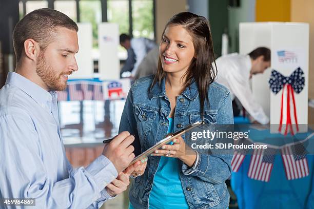 woman taking exit poll interview on election day - election 2013 stock pictures, royalty-free photos & images