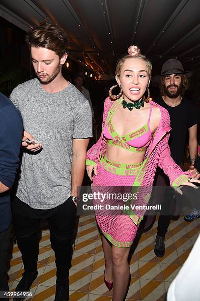 Patrick Schwarzenegger and Miley Cyrus attend Jeremy Scott & Moschino Party with Barbie on December 4, 2014 in Miami Beach, Florida.