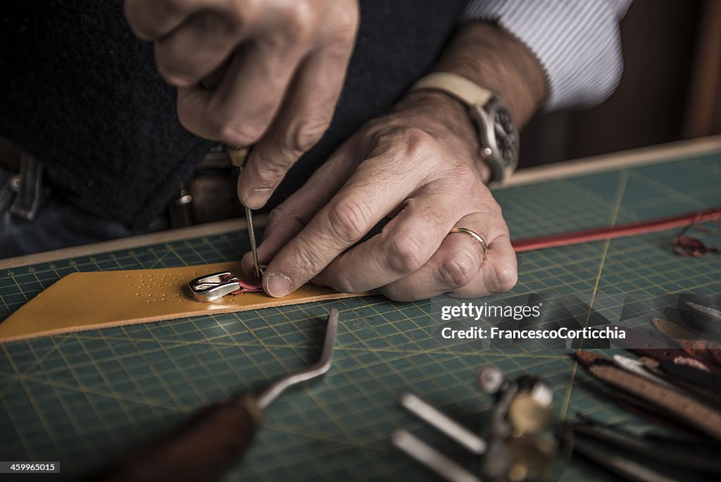 Artisan working with leather