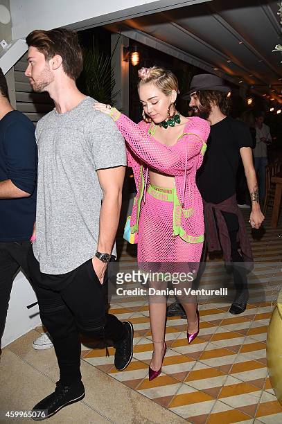 Patrick Schwarzenegger and Miley Cyrus attend Jeremy Scott & Moschino Party with Barbie on December 4, 2014 in Miami Beach, Florida.