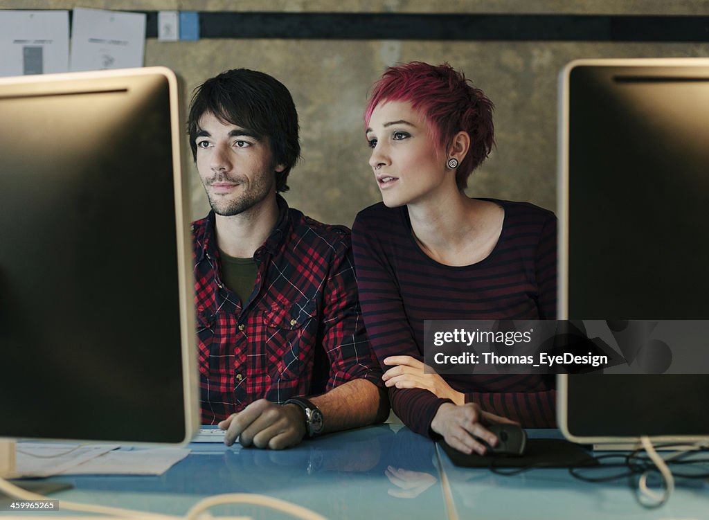 Businesspeople collaborating while working on computer