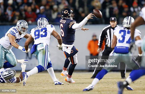 Jay Cutler of the Chicago Bears throws an incomplete pass as he is rushed by Tyrone Crawford and Anthony Spencer of the Dallas Cowboys during the...