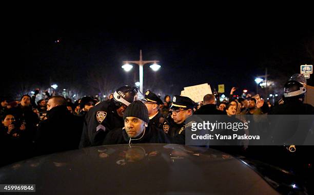 Police arrest a man on a passenger car in traffic standstill on the West Side Highway during a protest December 4, 2014 in New York City. Protests...