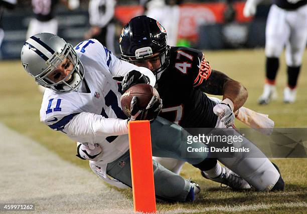 Cole Beasley of the Dallas Cowboys reaches for the end zone to score as Chris Conte of the Chicago Bears defends during the third quarter of a game...