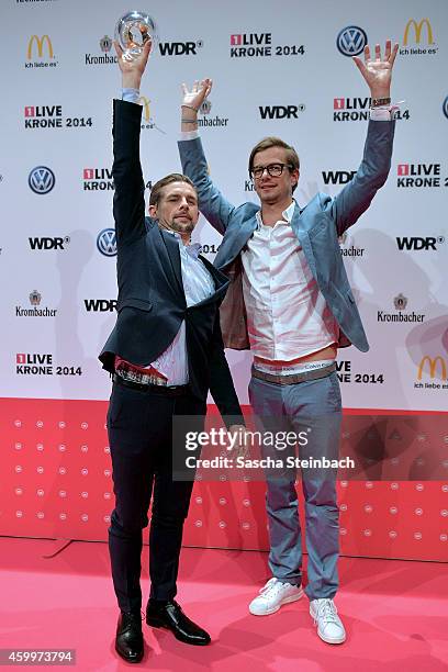 Joko Winterscheidt and Klaas Heufer-Umlauf pose with the award during the 1Live Krone 2014 at Jahrhunderthalle on December 4, 2014 in Bochum, Germany.