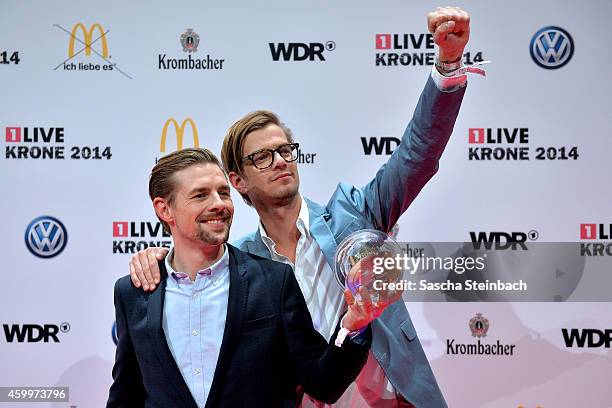 Joko Winterscheidt and Klaas Heufer-Umlauf pose with the award during the 1Live Krone 2014 at Jahrhunderthalle on December 4, 2014 in Bochum, Germany.