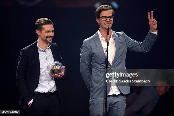 Klaas Heufer-Umlauf and Joko Winterscheidt celebrate winning the 1Live Krone award during the 1Live Krone 2014 at Jahrhunderthalle on December 4,...