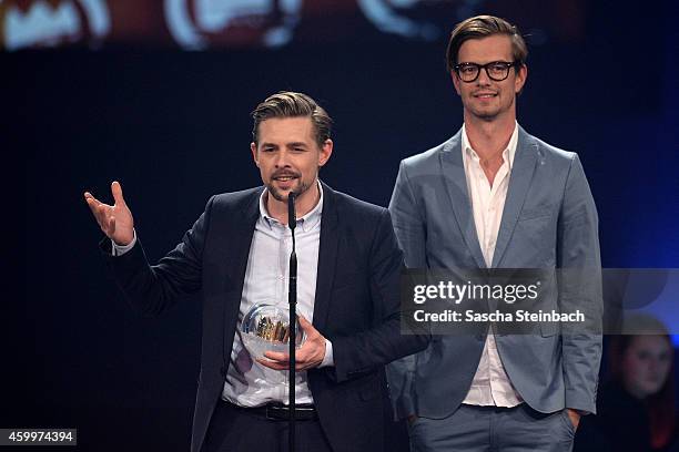 Klaas Heufer-Umlauf and Joko Winterscheidt celebrate winning the 1Live Krone award during the 1Live Krone 2014 at Jahrhunderthalle on December 4,...