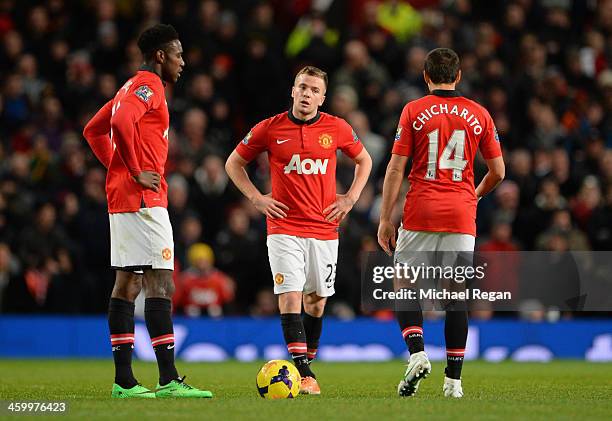 Tom Cleverley of Manchester United and his team-mate Danny Welbeck react after conceding a second goal during the Barclays Premier League match...