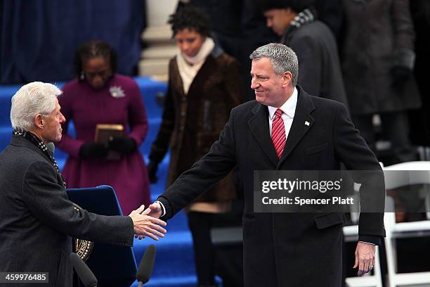 New York City's 109th Mayor, Bill de Blasio , shakes hands with former President Bill Clinton at City Hall before being sworn in on January 1, 2014...