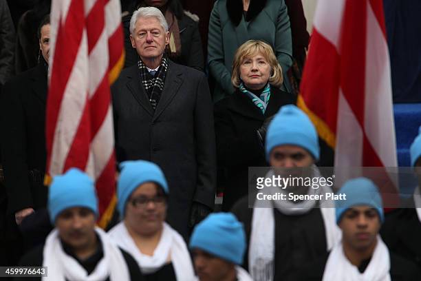 Hillary and Bill Clinton watch as New York City's 109th Mayor Bill de Blasio walks onto stage with his family at City Hall on January 1, 2014 in New...