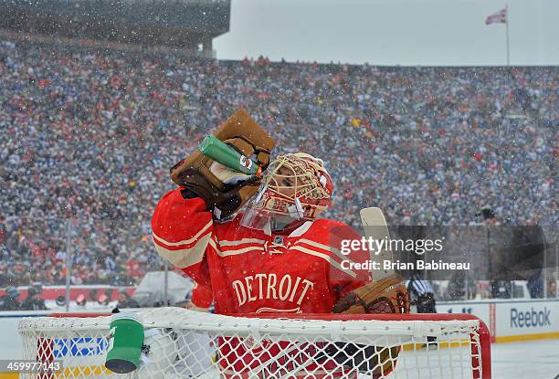 Goaltender Jimmy Howard of the Detroit Red Wings takes a drink of water during a break in game action in the first period of the 2014 Bridgestone NHL...