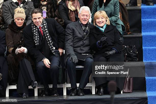 Hillary and Bill Clinton sit with New York Governor Andrew Cuomo and his girlfriend Sandra Lee as they watch ceremonies for New York City's 109th...