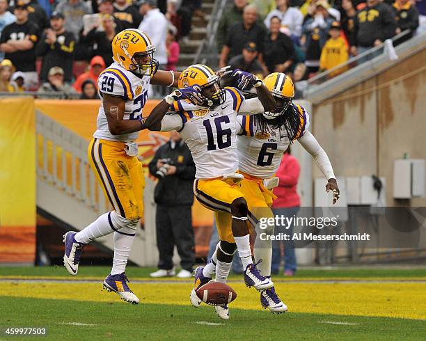 Defensive back Tre'Davious White of the LSU Tigers celebrates with Craig Loston and Rickey Jefferson after intercepting a first half pass against the...