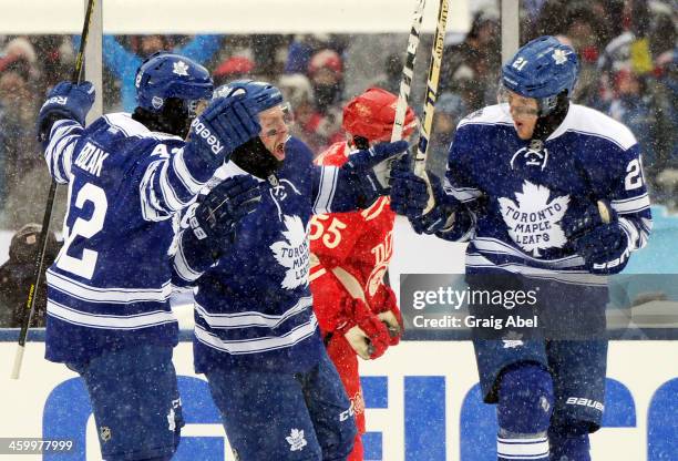 Tyler Bozak, Phil Kessel and James van Riemsdyk of the Toronto Maple Leafs celebrate van Riemsdyk's goal against the Detroit Red Wings during the...