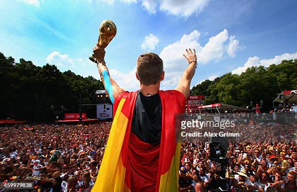 Bastian Schweinsteiger celebrates on stage at the German team victory ceremony July 15, 2014 in Berlin, Germany. Germany won the 2014 FIFA World Cup...