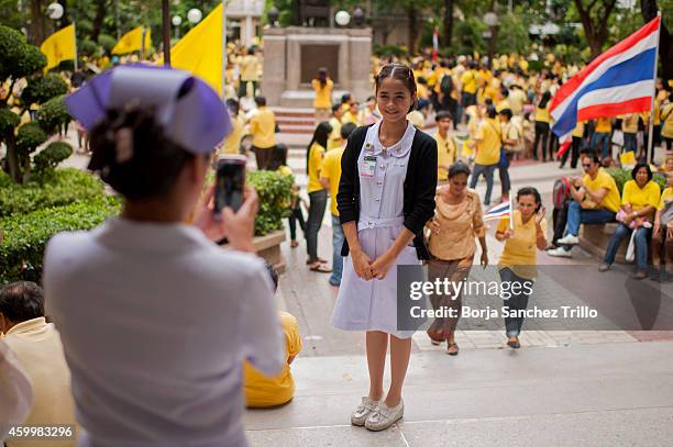 Two nurse take a picture as Thai well-wishers gather at Siriraj Hospital on December 5, 2014 in Bangkok, Thailand. Thailand celebrates their King's...