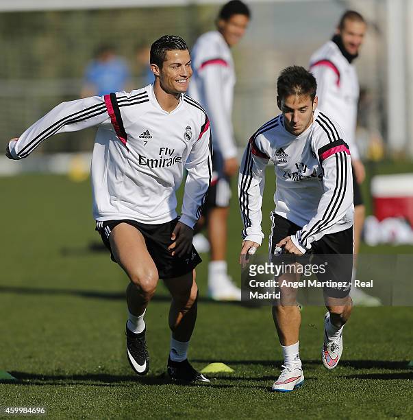 Cristiano Ronaldo and Alvaro Medran of Real Madrid exercise during a training session at Valdebebas training ground on December 5, 2014 in Madrid,...