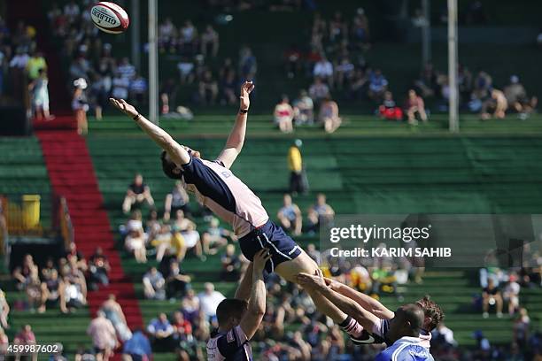 Scott Riddell of Scotland jumps for the ball during their rugby match against Samoa on the first day of the Dubai leg of IRB's Sevens World Series on...