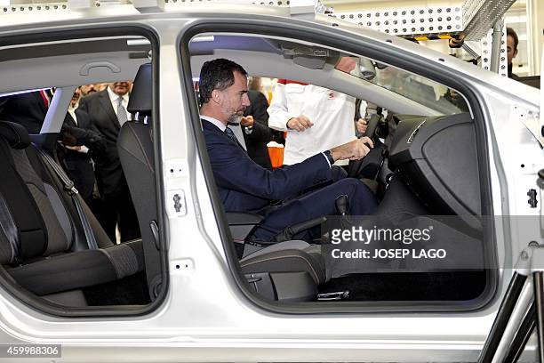 Spain's King Felipe VI visits an assembly line of the Seat factory in Martorell, near Barcelona, on December 5 on the occasion of the 30th...