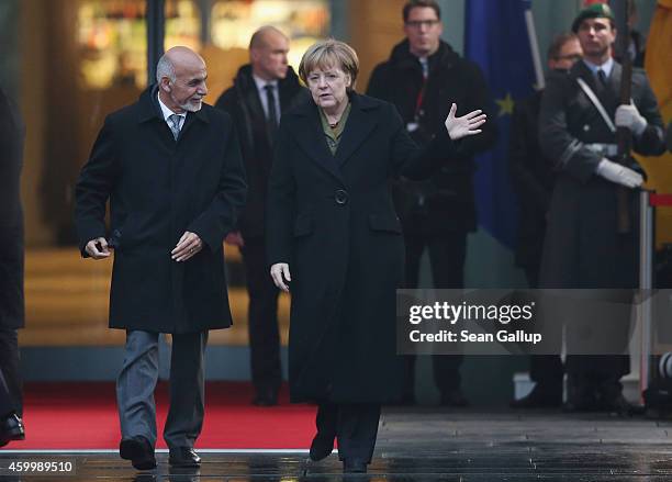 German Chancellor Angela Merkel and Afghan President Ashraf Ghani chat upon Ghani's arrival at the Chancellery on December 5, 2014 in Berlin,...