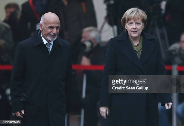 German Chancellor Angela Merkel and Afghan President Ashraf Ghani chat upon Ghani's arrival at the Chancellery on December 5, 2014 in Berlin,...