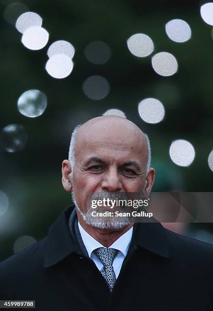 Afghan President Ashraf Ghani walks past a Chrismtas tree upon his arrival at the Chancellery to meet with German Chancellor Angela Merkel on...