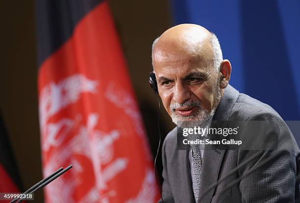 Afghan President Ashraf Ghani speaks to the media with German Chancellor Angela Merkel following talks at the Chancellery on December 5, 2014 in...