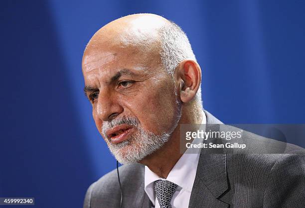 Afghan President Ashraf Ghani speaks to the media with German Chancellor Angela Merkel following talks at the Chancellery on December 5, 2014 in...