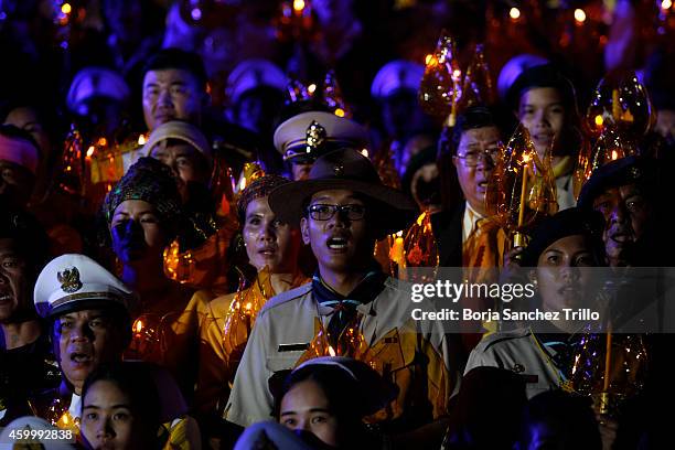 People hold candles during a candle light ceremony for King's birthday at Sanam Luang on December 5, 2014 in Bangkok, Thailand. Thailand celebrates...