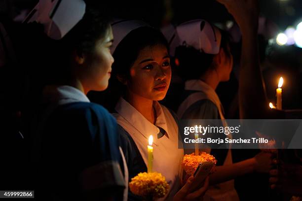 Nurses hold candles during a candle light ceremony for King's birthday at Sanam Luang on December 5, 2014 in Bangkok, Thailand. Thailand celebrates...