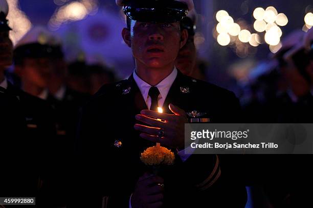 Soldier holds a candle during a candle light ceremony for King's birthday at Sanam Luang on December 5, 2014 in Bangkok, Thailand. Thailand...