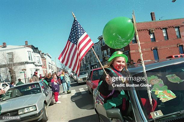 At the St. Patrick's Day Parade Margie Hanlon rides down East 4th street in an unsanctioned motorcade.