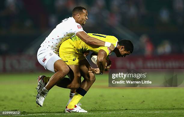 Dan Norton of England tackles Pama Fou of Australia during day one of the Emirates Dubai Sevens - HSBC Sevens World Series on December 5, 2014 in...