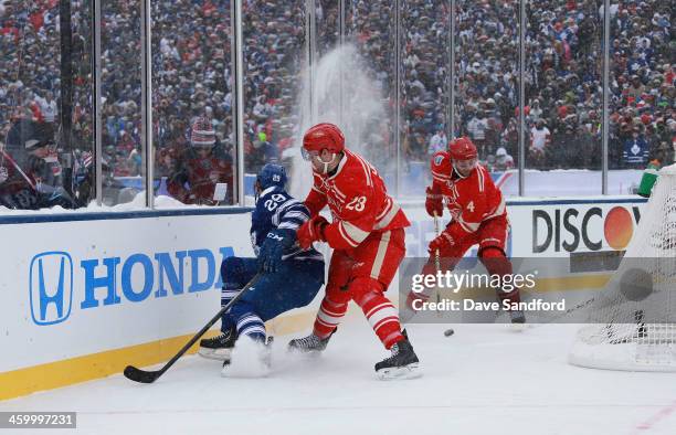 Jakub Kindl of the Detroit Red Wings plays the puck as teammate Brian Lashoff of the Detroit Red Wings cuts off Jerry D'Amigo of the Toronto Maple...