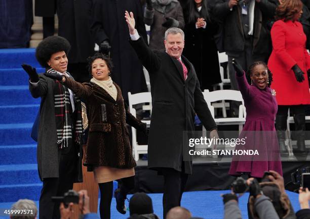 New York Mayor Bill de Blasio waves to the crowd after being sworn in as New York City Mayor on the steps of City Hall in Lower Manhattan on January...