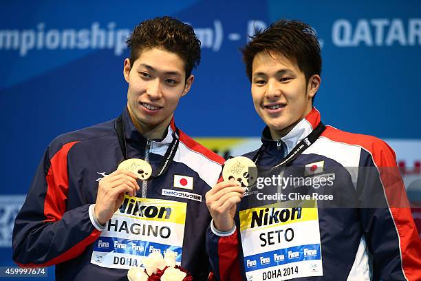 Kosuku Hagino and Daiya Seto of Japan celebrate on the podim after the Men's 200m Individual Medley Final during day three of the 12th FINA World...